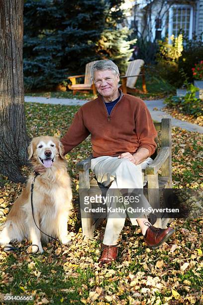 66 year old senior man with golden retriever dog - 65 year old stock-fotos und bilder