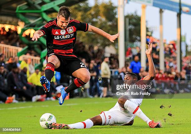 Giulio Donati of the Bayer Leverkusen jumps over Armando Vargas of the Indepediente Santa Fe during the match at the ESPN Wide World of Sports...