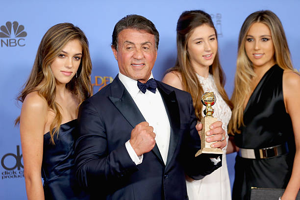 Actor Sylvester Stallone , winner of Best Supporting Performance in a Motion Picture for 'Creed,' poses in the press room with daughters Sistine,...