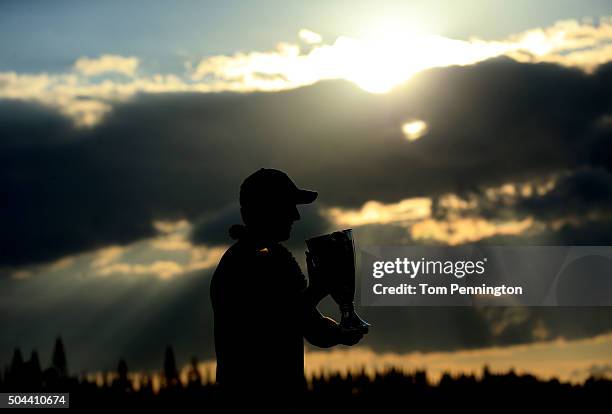 Jordan Spieth celebrates with the trophy after winning the final round of the Hyundai Tournament of Champions at the Plantation Course at Kapalua...