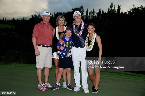 Jordan Spieth poses on the 18th green with his mom Chris, father Shawn, sister Ellie and girlfriend Annie Verret after winning the final round of the...