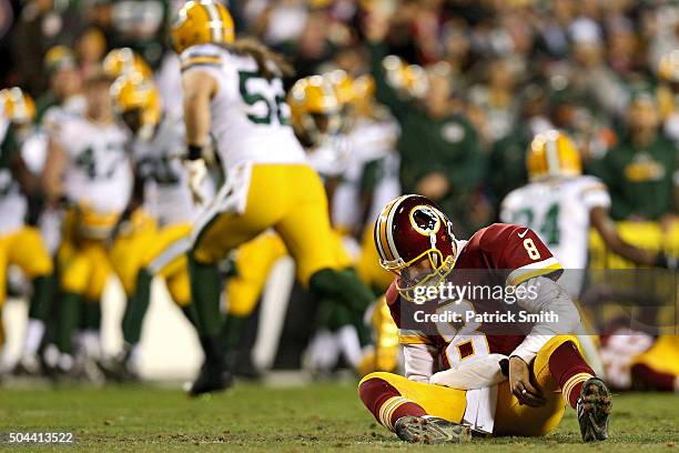 Quarterback Kirk Cousins of the Washington Redskins looks on after taking a hit against the Green Bay Packers in the second quarter at FedExField on...