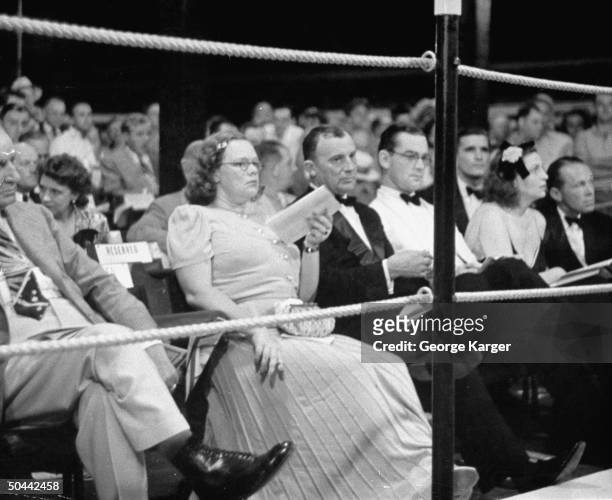 Mrs. Charles Shipman Payson and jock John Hay Whitney , watching the horse races.