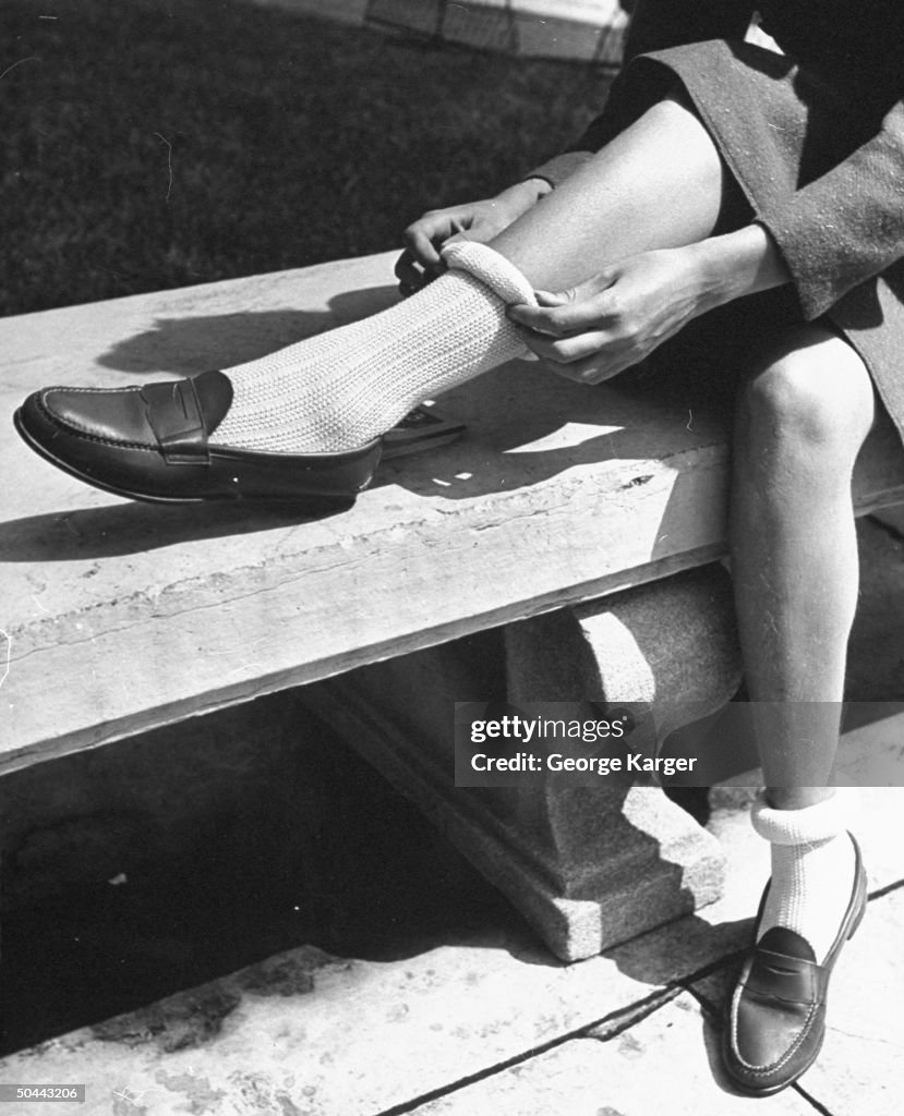 A young girl modeling rolling down her