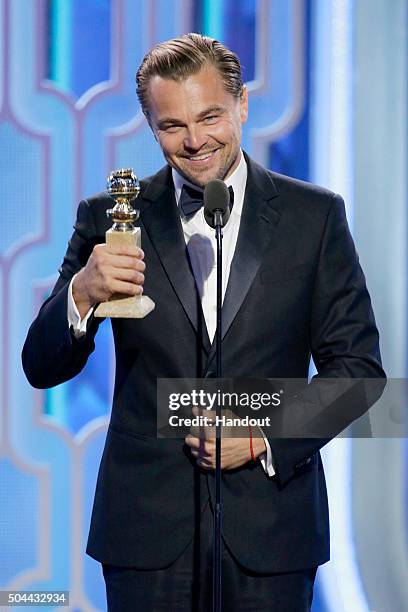 In this handout photo provided by NBCUniversal, Leonardo DiCaprio accepts the award for Best Actor - Motion Picture, Drama for "The Revenant" during...