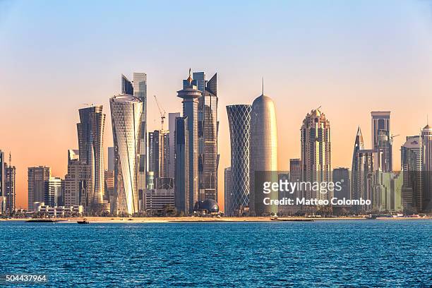 doha skyline and harbor at sunset, qatar, middle east - qatar stock pictures, royalty-free photos & images