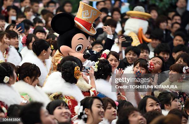 Disney character Mickey Mouse greets 20-year-old men and women during their "Coming-of-Age Day" celebration at Tokyo Disneyland in Urayasu, eastern...