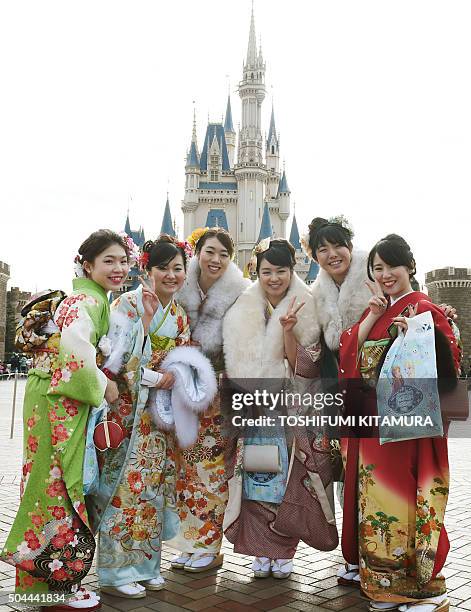 Year-old women in Kimono pose in front of the Cinderella Castle during their "Coming-of-Age Day" celebration at Tokyo Disneyland in Urayasu, eastern...