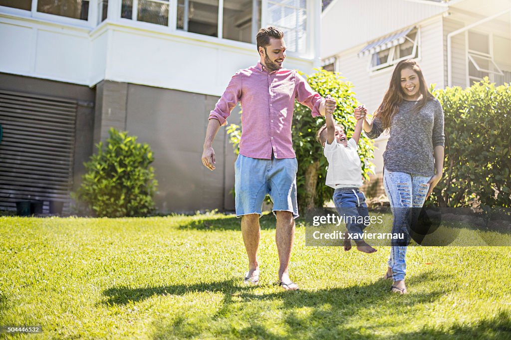 Parents playing with their son in garden