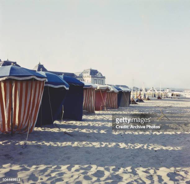 Cabanas on the beach at Deauville, France, circa 1965.