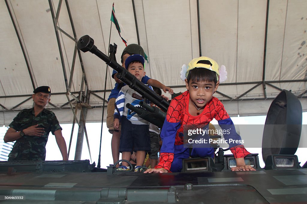 Children play on a tank during the National Children's Day...