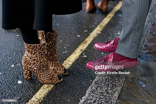 Guest wears leopard print peep toe ankle boot with a guest who wears pink loafers on day 1 of London Collections: Men on Januay 8, 2016 in London,...