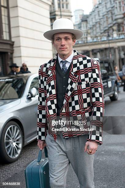 Collective Editor-In-Chief Jesse Stokkel wears a Hackett tie, Denham waistcoat, Sarah Hellen jacket, By Sju hat, and vintage bag on day 1 of London...
