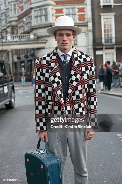 Collective Editor-In-Chief Jesse Stokkel wears a Hackett tie, Denham waistcoat, Sarah Hellen jacket, By Sju hat, and vintage bag on day 1 of London...