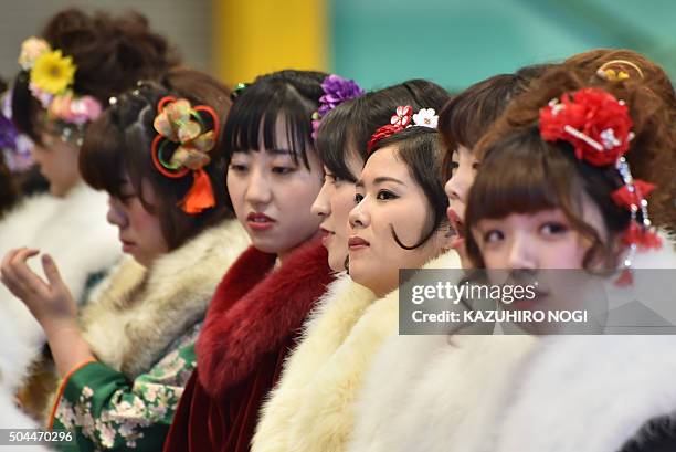 Twenty-year-old women wearing kimonos attend a "Coming-of-Age Day" celebration at the Toshimaen amusement park in Tokyo on January 11, 2016. The...