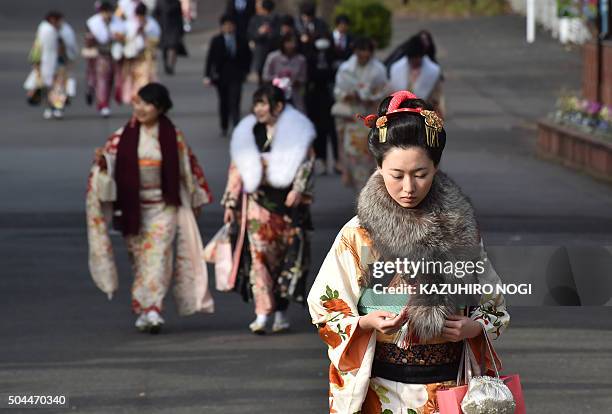 Twenty-year-old women wearing kimonos leave after attending a "Coming-of-Age Day" celebration at the Toshimaen amusement park in Tokyo on January 11,...