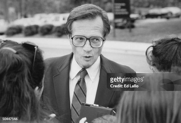 Host Larry King outdoors surrounded by people during Democratic Convention.