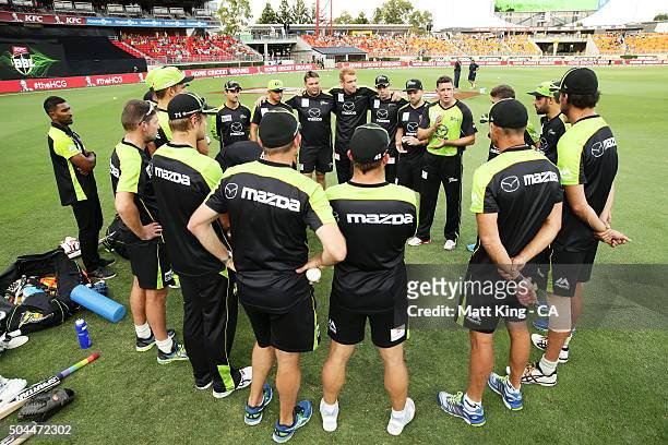 Thunder captain Michael Hussey speaks to his players before during the Big Bash League match between the Sydney Thunder and the Melbourne Renegades...