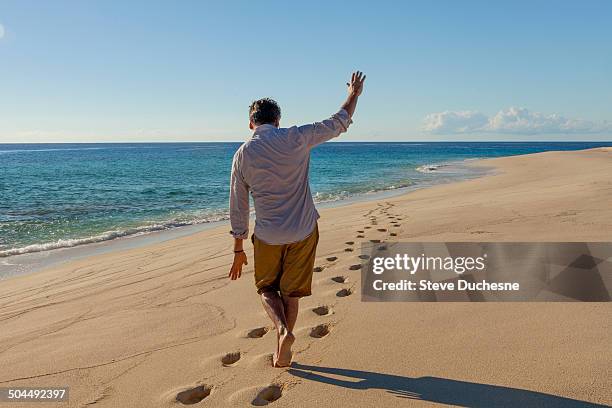 man walking on the footprint in the sand - san salvador stock pictures, royalty-free photos & images