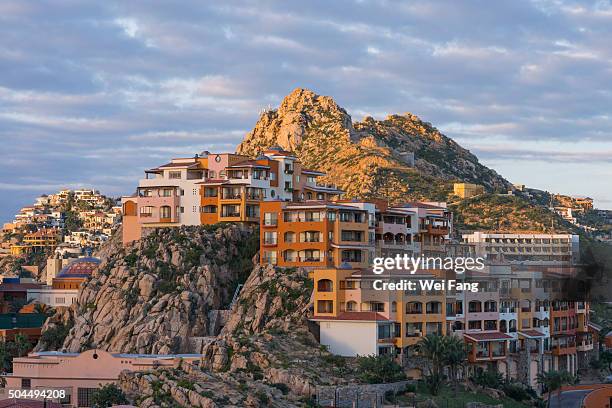 resorts on rock mountains - los cabos stock pictures, royalty-free photos & images