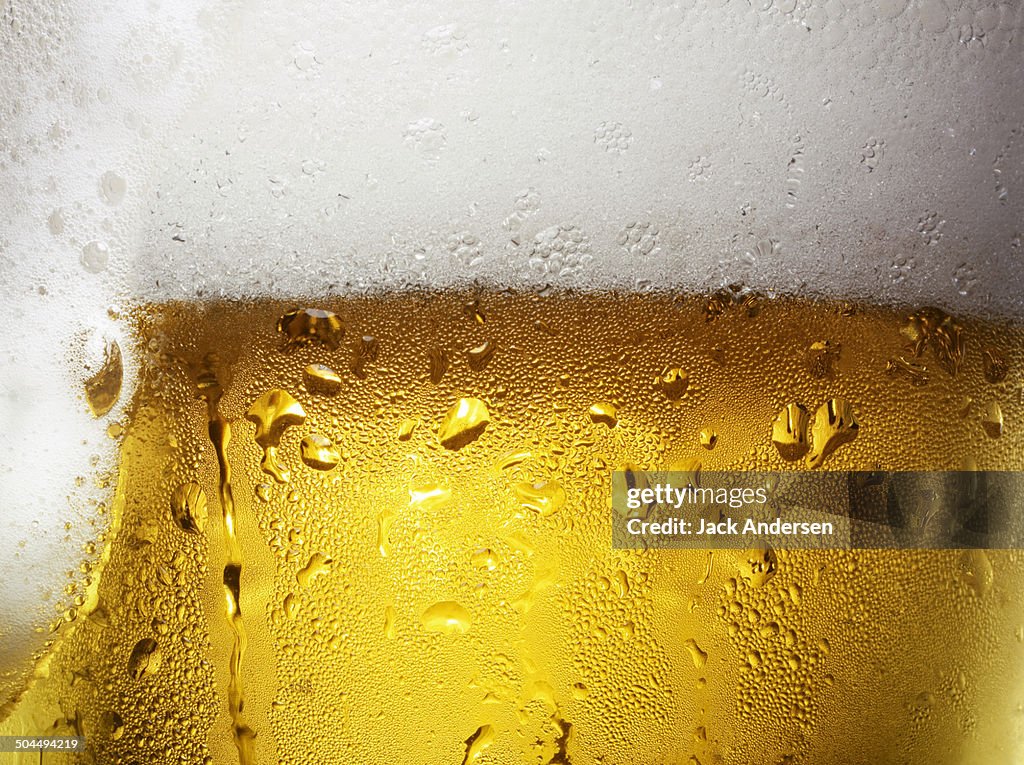 Overfull Glass of Beer with Condensation