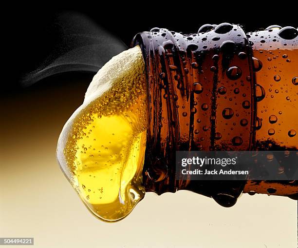 beer pouring from beer bottle - beer bottle stock pictures, royalty-free photos & images