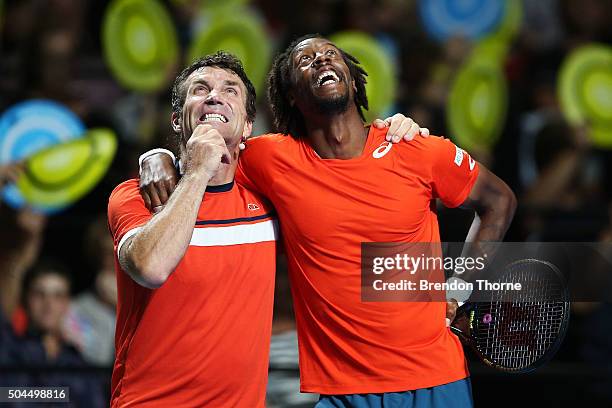 Gael Monfils of France embraces Pat Cash of Australia during the FAST4 Tennis exhibition match between Gael Monfils and Nick Kyrgios at Allphones...