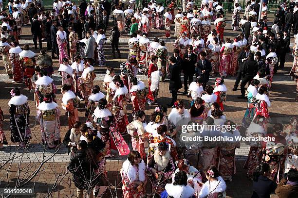 Men and women dressed in Kimono and suits attend the Coming of Age Day ceremony outside of Noevir Stadium on January 11, 2016 in Kobe, Japan. The...