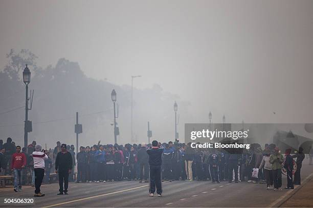 Children practice marching for the Republic Day Parade near the India Gate monument shrouded in smog in New Delhi, India, on Monday, Jan. 11, 2016. A...