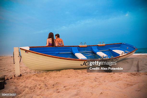 two girls stay at the jones beach at the sunset - jones beach stock pictures, royalty-free photos & images