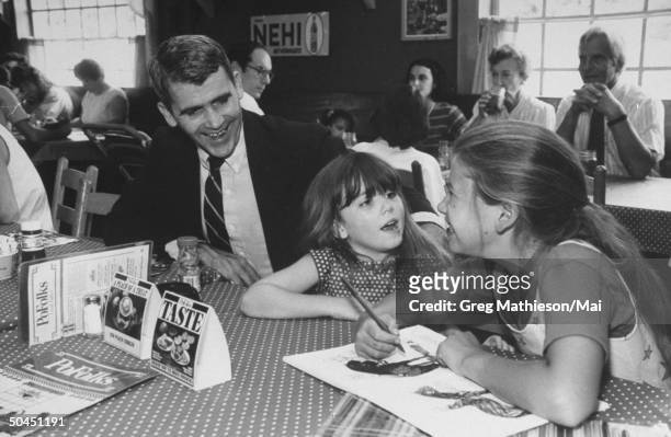 Lt. Col. Oliver North with daughters Dornin and Sarah relaxing at restaurant.