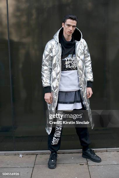 Model Vlad B wears a Vfiles coat, W.I.A tracksuit trousers and vest and Nike trainers on day 3 of London Collections: Men on Januay 10, 2016 in...