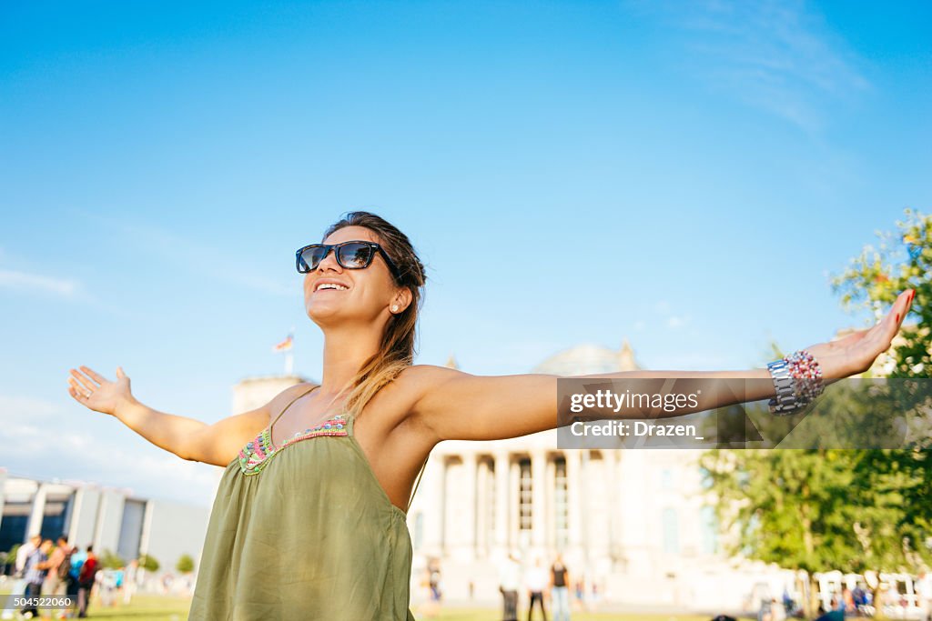 Pretty young woman feeling relaxed near Bundestag in Berlin