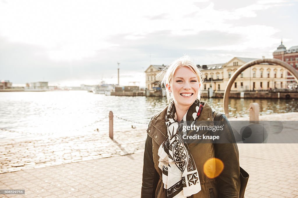 Woman in city in spring sunshine