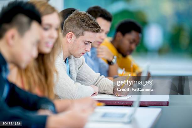 working on a homework assignment - classroom university stock pictures, royalty-free photos & images