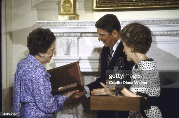 Philanthropist Alice Tully being presented with National Medal of Arts by Pres. Ronald W. Reagan and his wife .