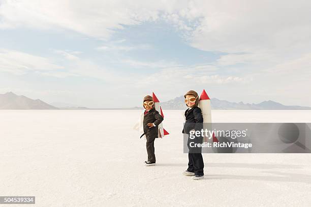 young business boys wearing rockets - businessman challenge stock pictures, royalty-free photos & images