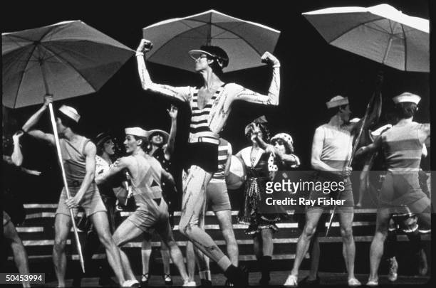 Actor Tommy Tune flexing his muscles with cast members in a scene from the stage musical Mack and Mabel.