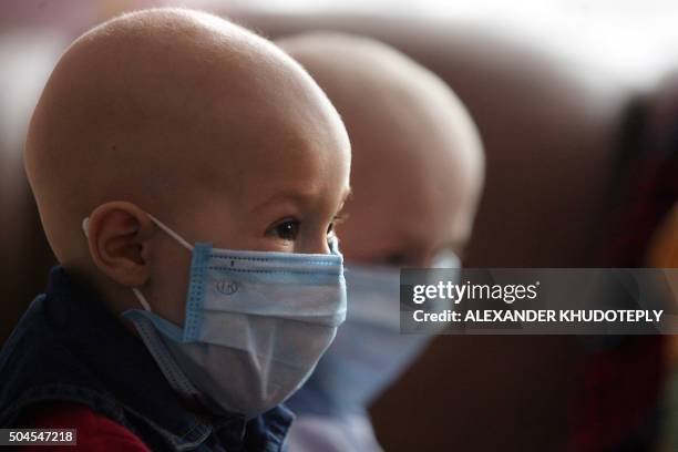 Children wears a mask at a hospital for people suffering from leukemia in the eastern Ukrainian city of Donetsk, on March 23, 2011. Ukrainian...