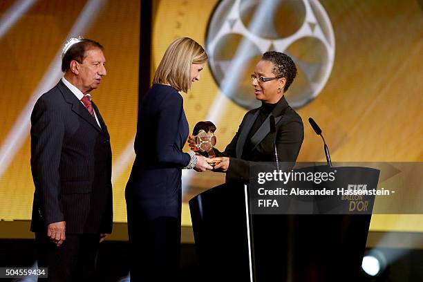 World Coach of the Year for Women's Football winner and United States Coach Jill Ellis of USA receives her award from Hope Powell during the FIFA...