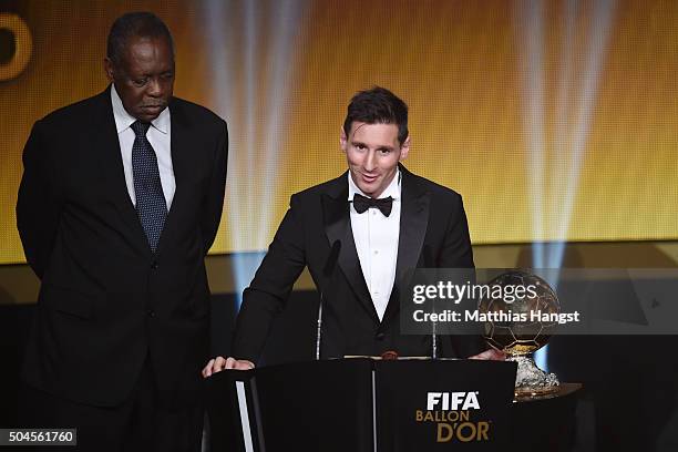 Lionel Messi of Argentina and FC Barcelona speaks to the audience after receiving the Ballon d'or from acting FIFA President Issa Hayatou during the...