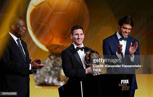 Ballon d'Or winner Lionel Messi of Argentina and Barcelona accepts his award with FIFA Acting President Issa Hayatou and Kaka of Brazil during the...