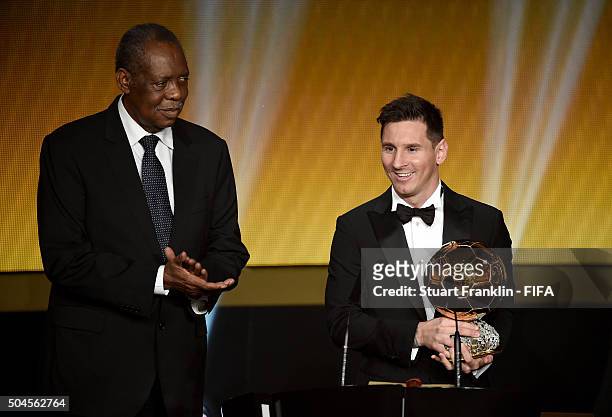 Ballon d'Or winner Lionel Messi of Argentina and Barcelona accepts his award with FIFA Acting President Issa Hayatou during the FIFA Ballon d'Or Gala...