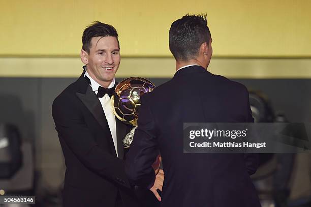 Lionel Messi of Argentina and FC Barcelona the winner of the Ballon d'or is congratulated byCristiano Ronaldo of Portugal and Real Madrid during the...