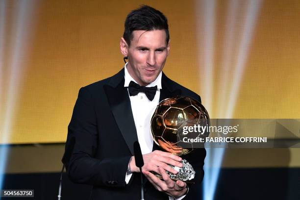 Barcelona and Argentina's forward Lionel Messi holds his trophy after receiving the 2015 FIFA Ballon d'Or award for player of the year during the...