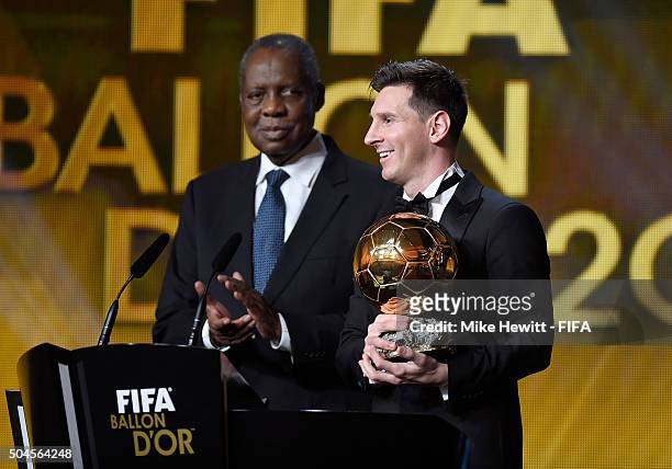 Ballon d'Or winner Lionel Messi of Argentina and Barcelona accepts his award with FIFA Acting President Issa Hayatou during the FIFA Ballon d'Or Gala...