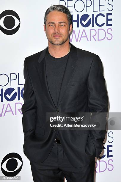 Actor Taylor Kinney poses for photos in the press room during the People's Choice Awards 2016 at Microsoft Theater on January 6, 2016 in Los Angeles,...