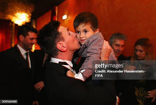 Ballon d'Or winner Lionel Messi of Argentina and Barcelona kisses his son Thiago after the FIFA Ballon d'Or Gala 2015 at the Kongresshaus on January...