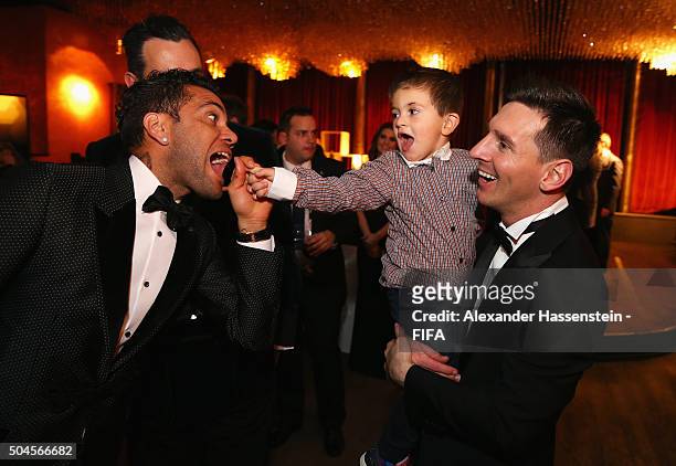 Dani Alves of Brazil and Barcelona jokes around with FIFA Ballon d'Or winner Lionel Messi of Argentina and Barcelona and his son Thiago after the...