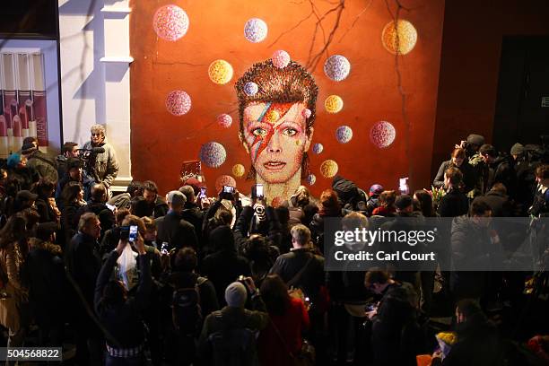 Members of the media and public gather by a mural of David Bowie in Brixton on January 11, 2016 in London, England. British music and fashion icon...